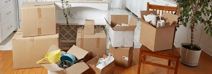 Packed moving boxes and household items in a kitchen before move-out or move-in cleaning, Dallas, TX.